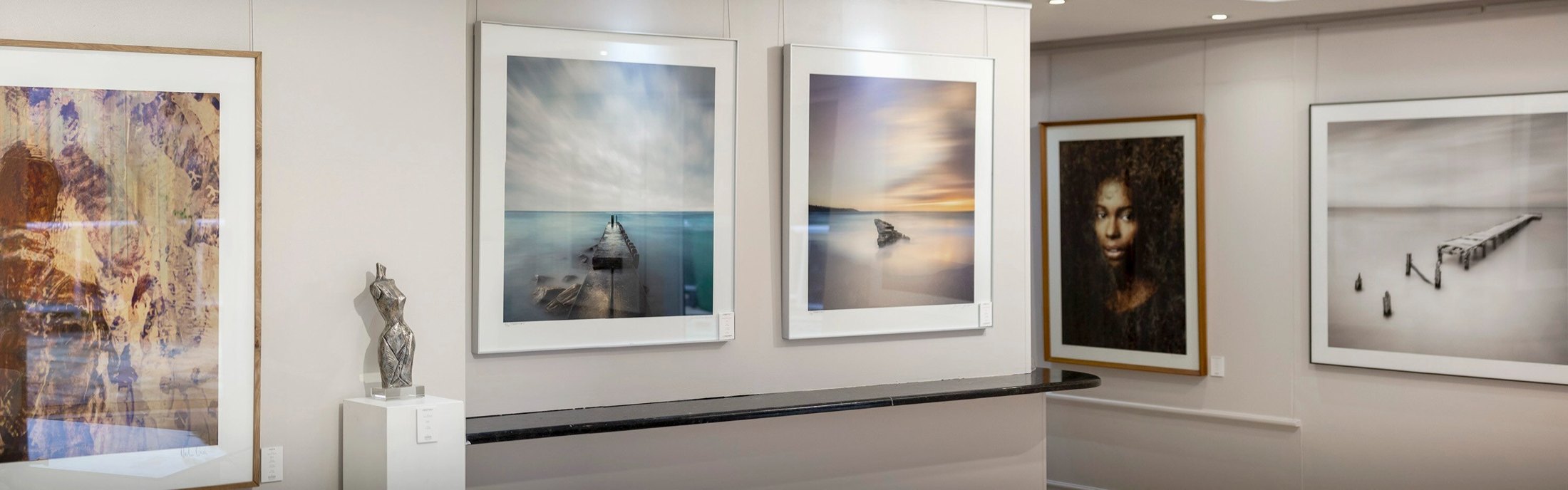 Framed fine art photographs by Martin Osner on the walls of the Hout Bay gallery