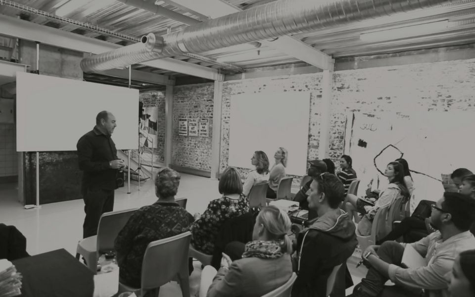 Martin Osner teaching a group of students in a workshop at the Photography School and Art Academy.