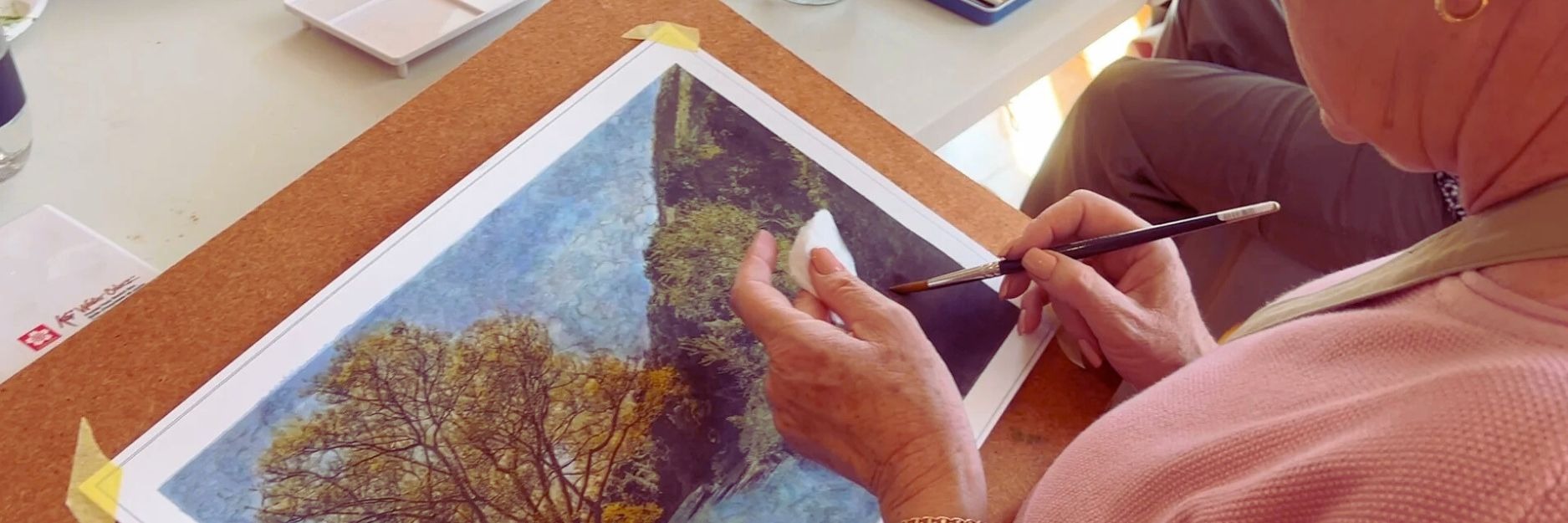 Woman creating a fine art photograph using a paint brush