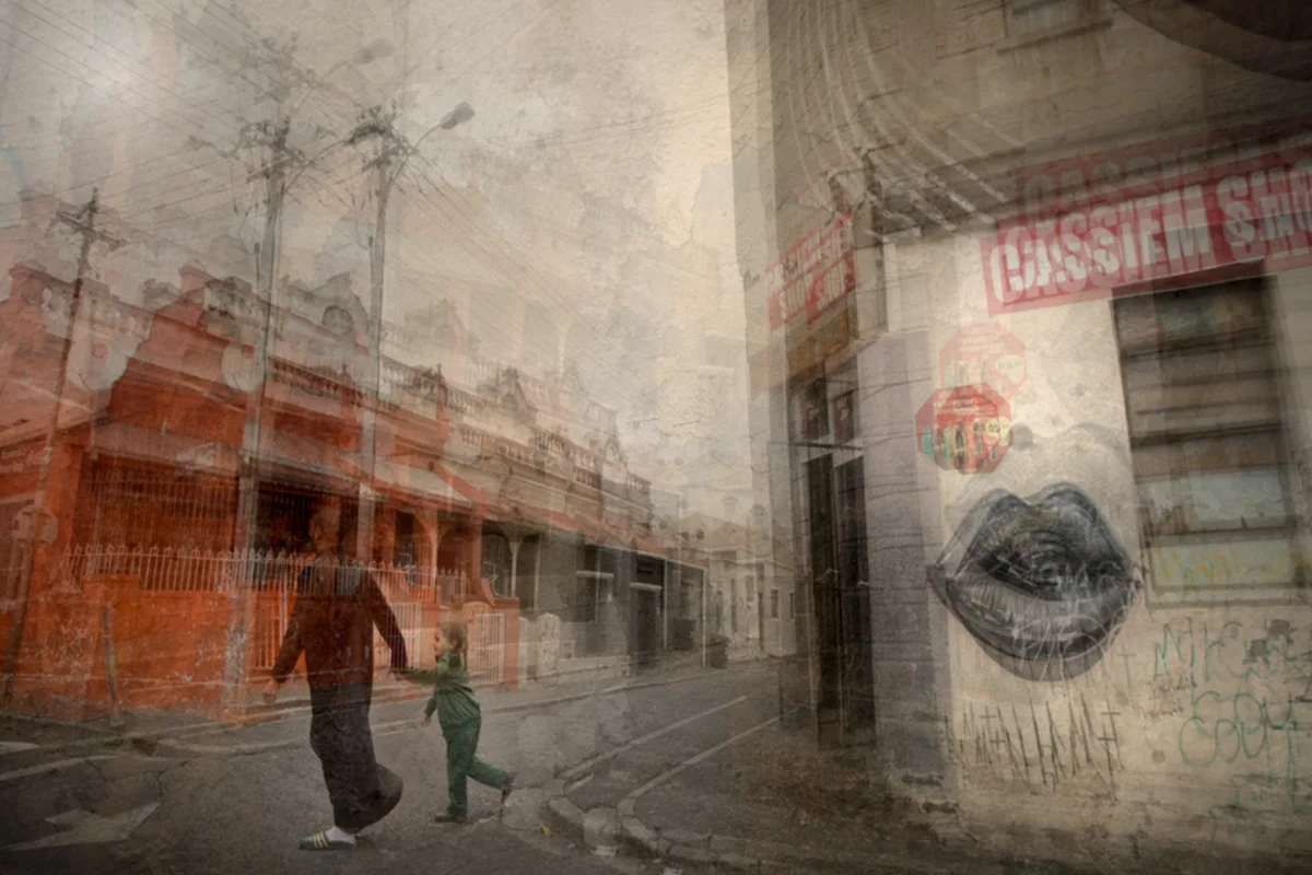 Layered street scene of a parent and child beside a painted wall