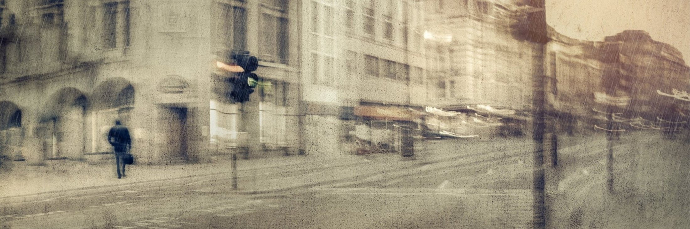 Figures passing city buildings, blurred into a fine art photograph by Martin Osner